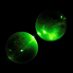 Green laser transmitted through glass spheres