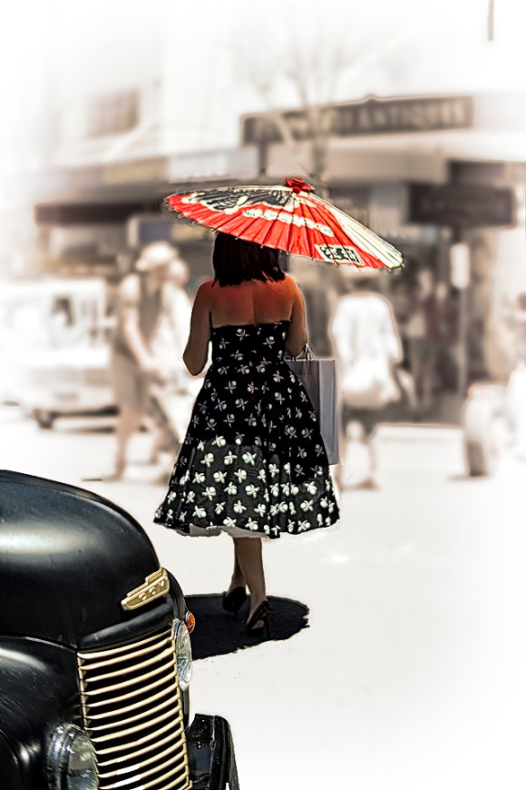 Woman shaded by a parasol on a blazing hot day